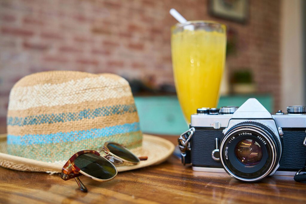 A table with a hat, sunglasses, and camera