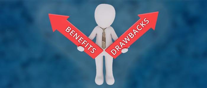 A person holding two arrow signs, one with the word benefits and another with the word drawbacks on it