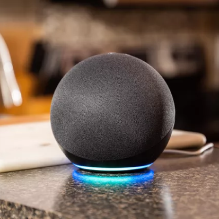 A round black speaker on a table