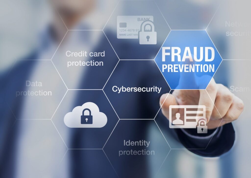 An image of someone pressing a digital button that reads “Fraud Prevention”