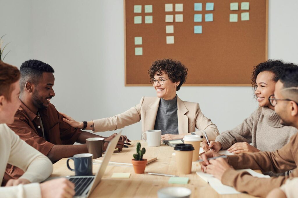 Team of people sitting around a table and smiling