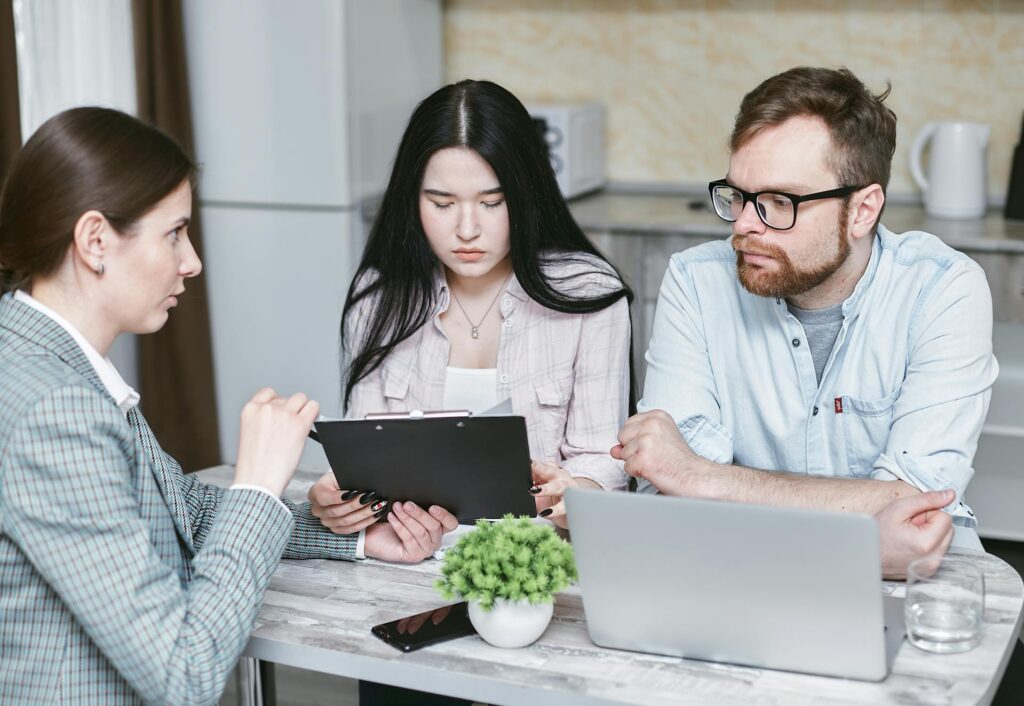 A consultant talking to a couple reading a document