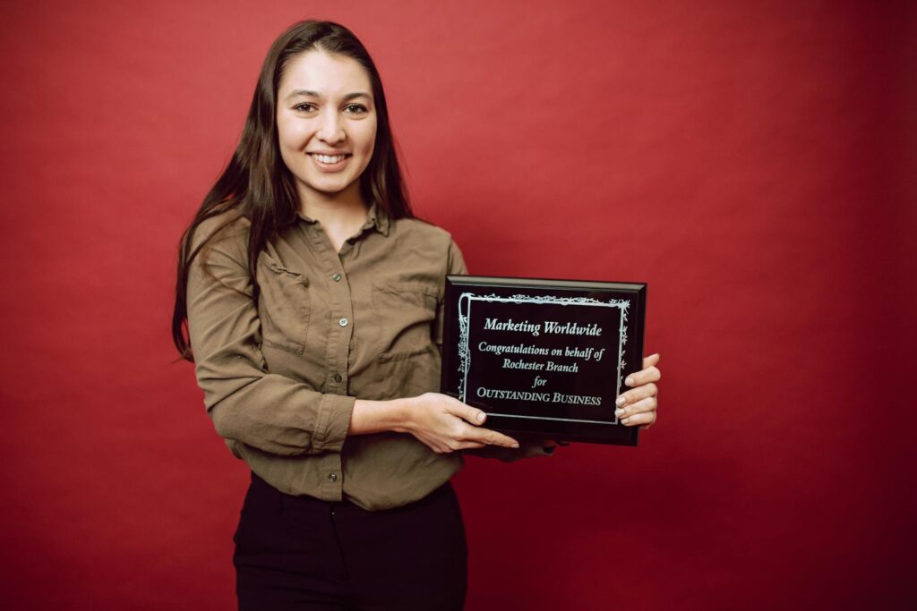 Woman posing with work award