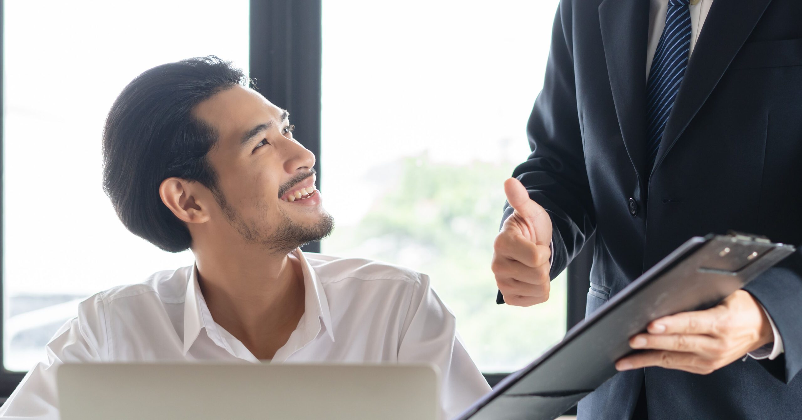 A cheerful employee receiving recognition at their desk, symbolizing workplace appreciation, alongside an e-commerce website showcasing personalized recommendations for a customer