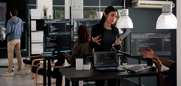 A collaborative team of IT, legal, and compliance professionals brainstorming security strategies in a modern office, with a whiteboard emphasizing 'Privacy by Design' and 'Compliance Audit.