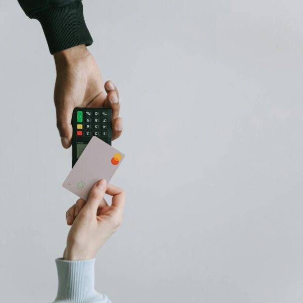A person using a card to pay for something after buying prepaid cards