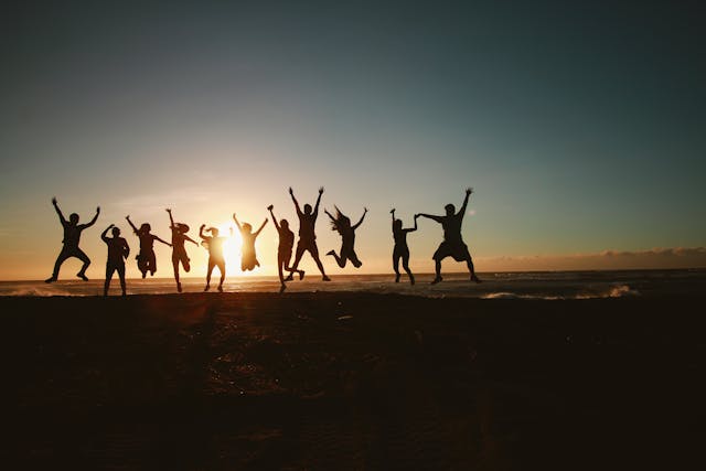 A group of people at the beach jumping in excitement after joining a cloud-based loyalty program